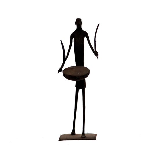 Standing Maadia beating dhol